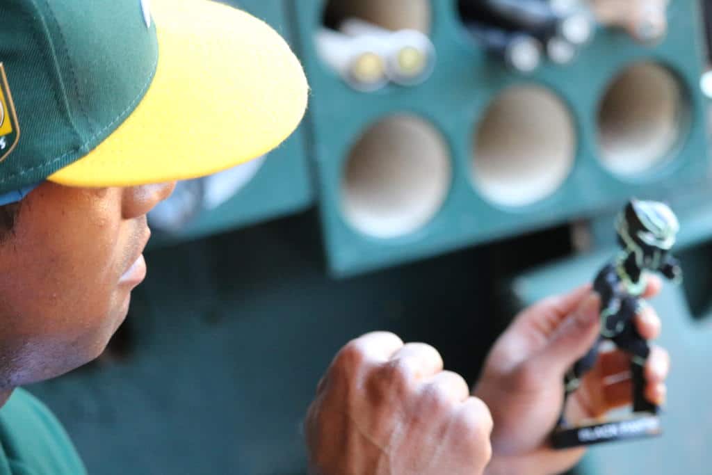 Khris Davis holding Black Panther Bobblehead